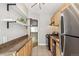 Kitchen featuring granite countertops, open shelving, and stainless steel appliances at 1416 N Downing St # 1, Denver, CO 80218
