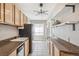 Bright kitchen featuring stainless steel refrigerator, wood cabinets and granite countertops at 1416 N Downing St # 1, Denver, CO 80218
