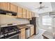 Kitchen featuring granite countertops, wood cabinets, and stainless steel appliances at 1416 N Downing St # 1, Denver, CO 80218