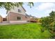 Charming backyard featuring a well-maintained lawn and a spacious deck at 4127 S Lewiston Cir, Aurora, CO 80013