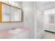Bathroom with a tub and shower combo featuring a single sink vanity and a large mirror at 4127 S Lewiston Cir, Aurora, CO 80013