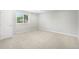 Bright bedroom featuring neutral walls, carpet floors, and a large window providing ample natural light at 4127 S Lewiston Cir, Aurora, CO 80013