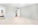 Bright bedroom with neutral carpet, and access to the ensuite bathroom and hallway at 4127 S Lewiston Cir, Aurora, CO 80013