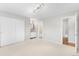Bright bedroom featuring neutral carpet, sliding closet doors, and ensuite bathroom access at 4127 S Lewiston Cir, Aurora, CO 80013