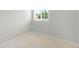 Bedroom featuring neutral carpet, white trim and a window with natural light at 4127 S Lewiston Cir, Aurora, CO 80013