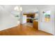 Open floor plan view of dining area leading to the kitchen with wood cabinetry at 4127 S Lewiston Cir, Aurora, CO 80013