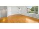 Spacious living room with hardwood floors and large windows, offering plenty of natural light at 4127 S Lewiston Cir, Aurora, CO 80013