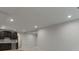Partially finished basement with wet bar and recessed lighting at 461 Muirfield Cir, Louisville, CO 80027