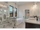 Modern bathroom featuring a soaking tub, a glass-enclosed shower, and dual vanities at 461 Muirfield Cir, Louisville, CO 80027