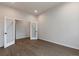 Bright bedroom featuring hardwood floors and modern doors at 461 Muirfield Cir, Louisville, CO 80027