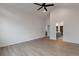 Primary bedroom with vaulted ceilings, a ceiling fan, and ensuite bathroom access at 461 Muirfield Cir, Louisville, CO 80027