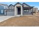 New home boasts stone accents, covered porch, and attached garage at 461 Muirfield Cir, Louisville, CO 80027