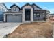New home boasts stone accents, covered porch, and attached garage at 461 Muirfield Cir, Louisville, CO 80027