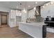 Modern kitchen featuring white cabinets, a center island, and stainless steel appliances at 461 Muirfield Cir, Louisville, CO 80027