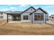 The rear of the house features a covered patio and several windows at 461 Muirfield Cir, Louisville, CO 80027