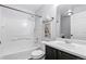 Bright bathroom featuring a tub, toilet, vanity, mirror, and white tile at 11898 W Tufts Pl, Morrison, CO 80465