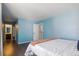 A nicely-sized bedroom with hardwood floors and views into the Primary bath and walk in closet at 11898 W Tufts Pl, Morrison, CO 80465