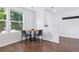 Dining area with hardwood floors, natural light from a window, and a minimalist table setting with modern chairs at 11898 W Tufts Pl, Morrison, CO 80465