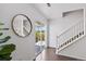 Bright entryway with dark wood floors, access to the backyard, staircase, and stylish mirror at 11898 W Tufts Pl, Morrison, CO 80465