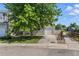 View of the front of the two-story home, showcasing the driveway, attached garage, and well-maintained lawn at 11898 W Tufts Pl, Morrison, CO 80465