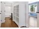 Hallway with hardwood floors, a cabinet, and bathroom at 11898 W Tufts Pl, Morrison, CO 80465