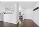 Open-concept layout with hardwood floors, connecting the living room, dining area, and entrance at 11898 W Tufts Pl, Morrison, CO 80465