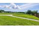 Lush green yard with scenic views and a concrete pathway at 11898 W Tufts Pl, Morrison, CO 80465