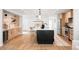 Bright kitchen features a large island, stainless appliances, and light wood cabinets at 1757 W 36Th Ave, Denver, CO 80211