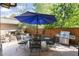 Relaxing patio featuring a large table with chairs, stone fireplace, and grill at 2042 S Clayton St, Denver, CO 80210