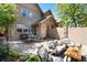 Inviting patio area with comfortable seating, outdoor grill, and lush landscaping and patio umbrella at 2042 S Clayton St, Denver, CO 80210