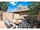 Inviting patio area with a cozy stone fireplace, comfortable seating and lush garden at 2042 S Clayton St, Denver, CO 80210