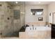 Elegant bathroom featuring a glass shower, a soaking tub, and tile floors at 2042 S Clayton St, Denver, CO 80210