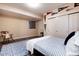 Charming bedroom featuring wood floors, a cozy rocking chair, and a large closet at 2042 S Clayton St, Denver, CO 80210