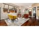 Cozy living room with hardwood floors, comfortable seating and a large window at 2042 S Clayton St, Denver, CO 80210