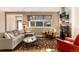 Comfortable living room featuring a sectional sofa, fireplace, and large window with outdoor views at 2042 S Clayton St, Denver, CO 80210