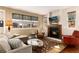 Inviting living room with a fireplace, ample seating, and large windows providing plenty of natural light at 2042 S Clayton St, Denver, CO 80210