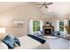 Bright and airy main bedroom with fireplace, vaulted ceiling, and large windows at 2042 S Clayton St, Denver, CO 80210