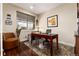Home office with wooden desk, a comfortable chair, and natural light from a window at 2042 S Clayton St, Denver, CO 80210