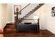 Staircase with wood treads and modern decor, next to a black media console at 2042 S Clayton St, Denver, CO 80210