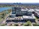 Modern condo building with many windows and a rooftop garden overlooking the city skyline and a lake at 4200 W 17Th Ave # 235, Denver, CO 80204