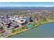 Panoramic aerial view showcases the community's proximity to a serene lake, tennis courts, and mountain views at 4200 W 17Th Ave # 235, Denver, CO 80204