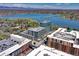 Stunning aerial view of a modern high-rise residential building next to a lake with mountain views at 4200 W 17Th Ave # 235, Denver, CO 80204