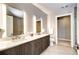 A modern bathroom with double sinks, granite countertop, and a large mirror at 4200 W 17Th Ave # 235, Denver, CO 80204