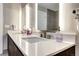 Modern bathroom vanity with dual sinks and lighted mirrors provides a bright and clean aesthetic at 4200 W 17Th Ave # 235, Denver, CO 80204