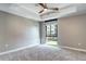 Spacious bedroom with tray ceiling, ceiling fan, and a large window providing ample natural light at 4200 W 17Th Ave # 235, Denver, CO 80204