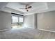The main bedroom featuring a modern ceiling fan, large windows, and concrete support column at 4200 W 17Th Ave # 235, Denver, CO 80204