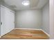 A gray and white bedroom with wood floors and a closet at 4200 W 17Th Ave # 235, Denver, CO 80204