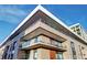 Exterior view showcasing the building's design and private balconies with glass railings at 4200 W 17Th Ave # 235, Denver, CO 80204