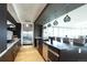 Modern kitchen featuring dark cabinets, stainless steel appliances, an island with seating, and stylish pendant lighting at 4200 W 17Th Ave # 235, Denver, CO 80204