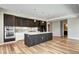 Modern kitchen with a large island, stainless steel appliances, and hardwood floors exudes contemporary charm at 4200 W 17Th Ave # 235, Denver, CO 80204